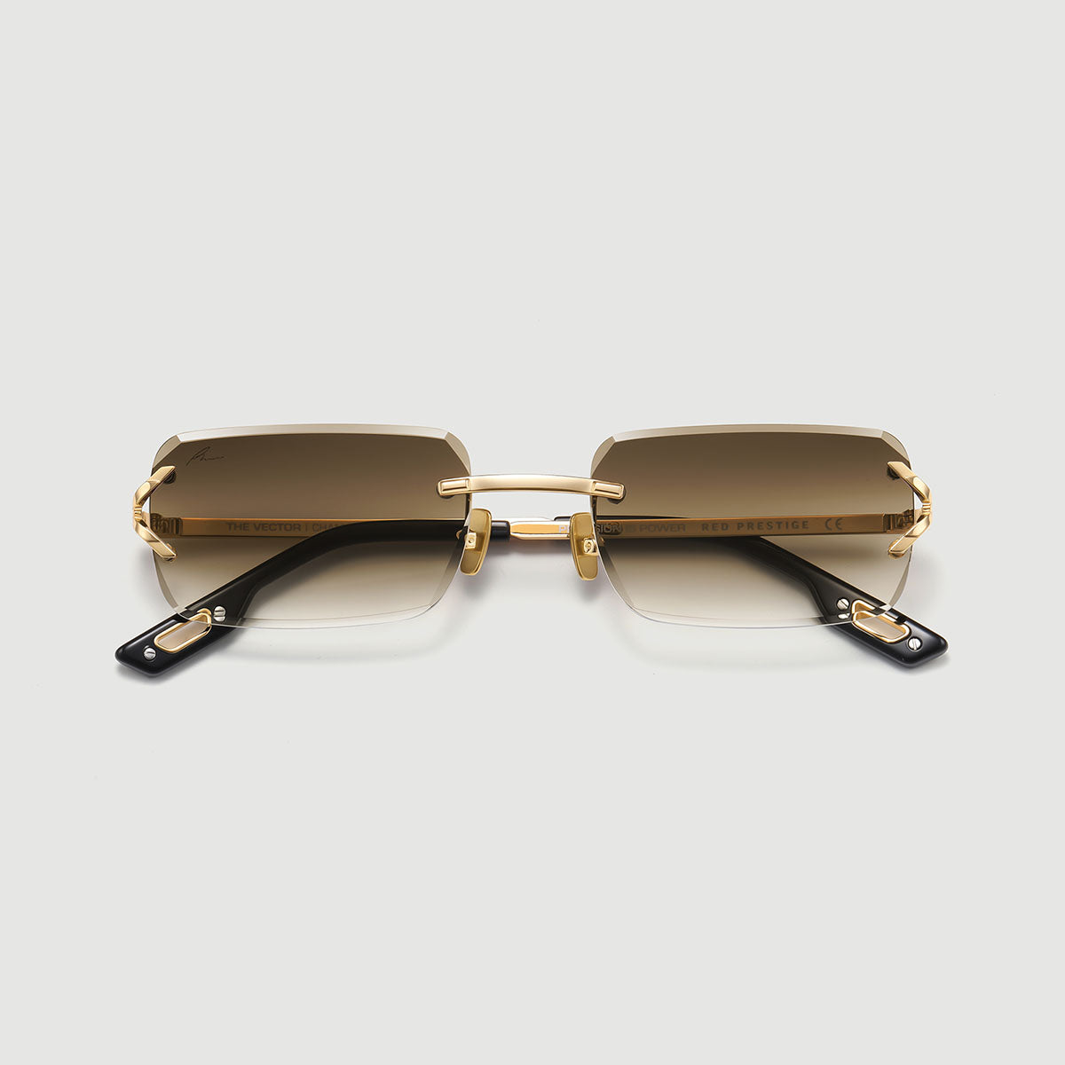 Gold-framed sunglasses with gradient lenses on a light gray background